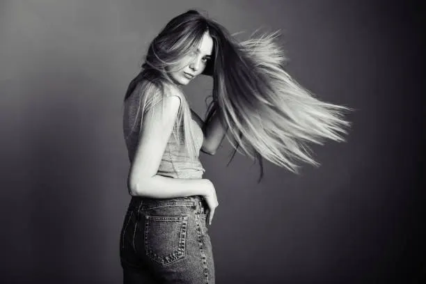 black and white photo of a girl with her hair in the background with free space for text
