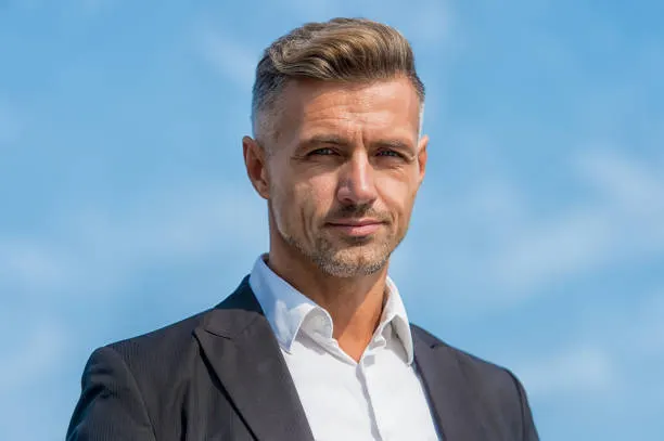 Hairdresser salon. Stylish hairstyle. Male face. Businessman concept. Facial care and ageing. Attractive mature man. Mature guy with grey hair and bristle outdoors. Men get more attractive with age.
